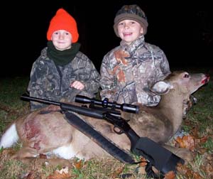 Two Young Hunters with Their Deer